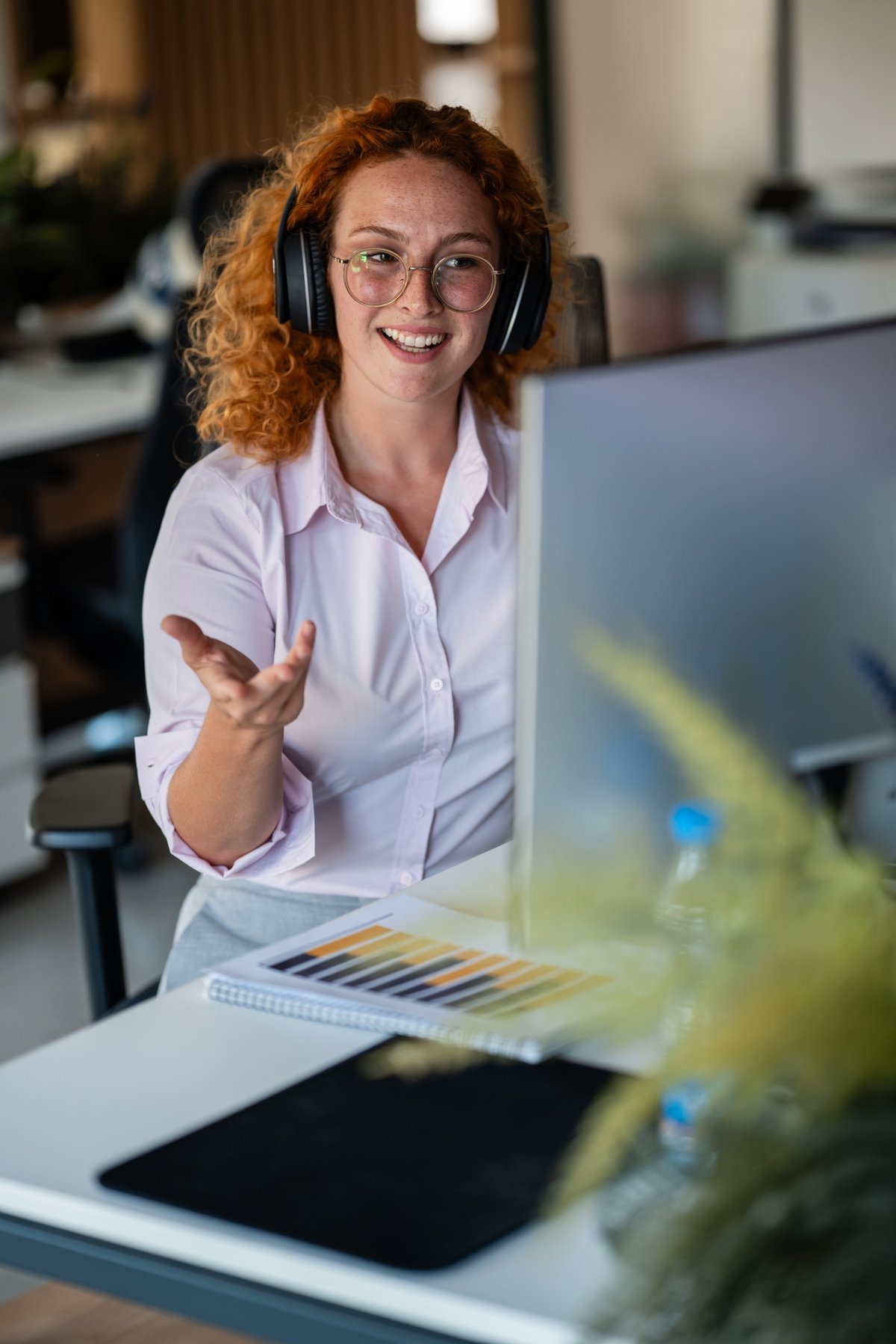 Cheerful young woman on a headset call helping with a quote request
