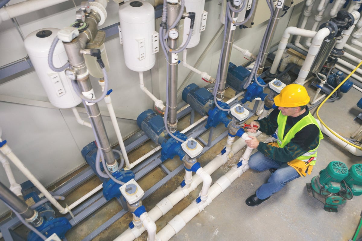 Technician working on industrial pumping equipment